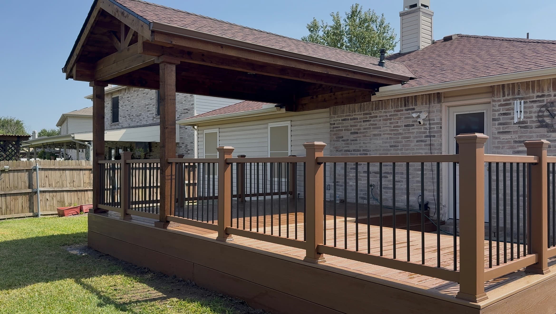 Covered patio with fireplace and TV