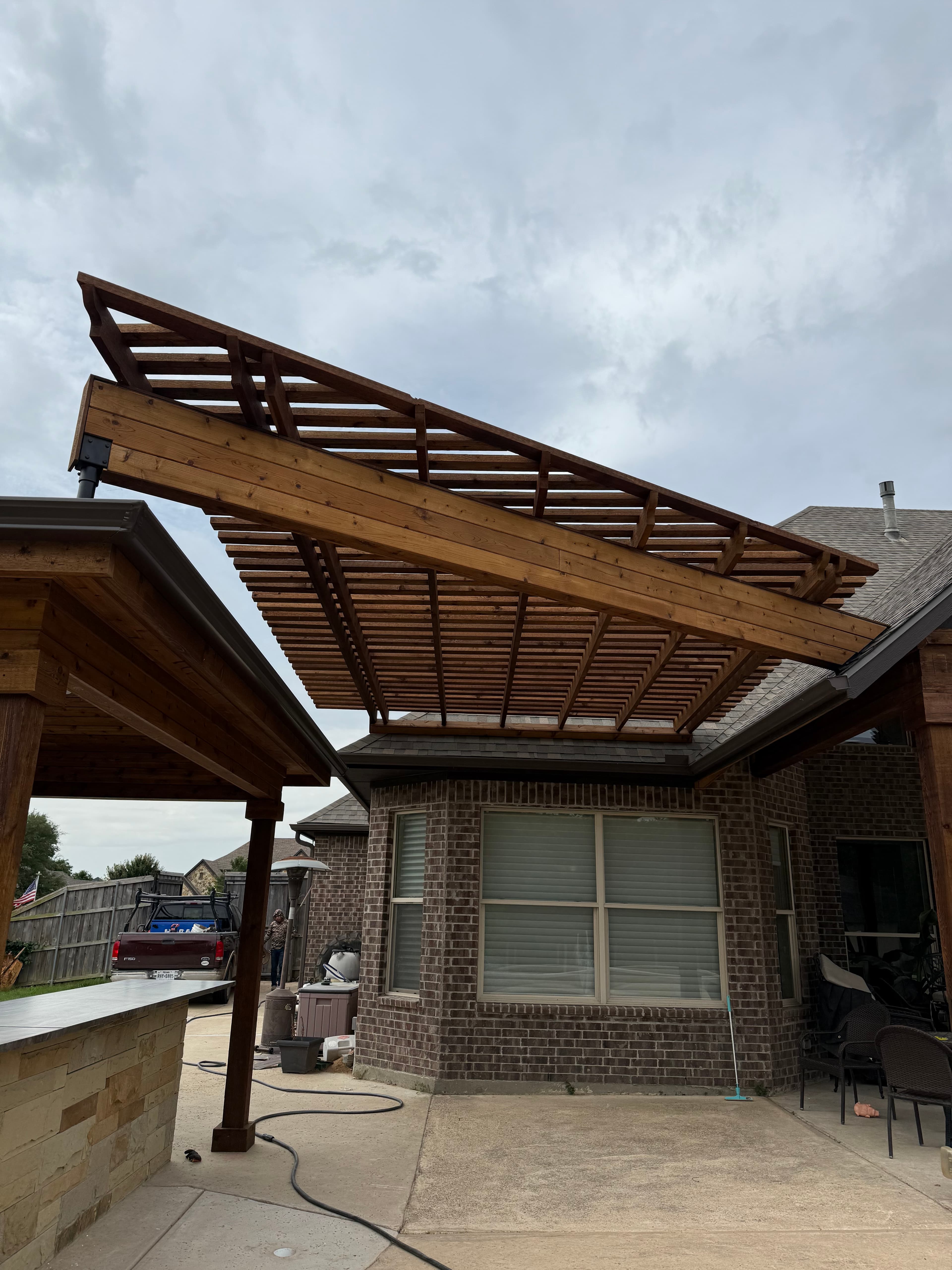 Pergola-style outdoor kitchen with finished framing